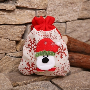 Detail of Christmas burlap gift bag featuring a 3D polar bear and red drawstring top
