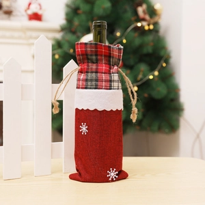 Red burlap Christmas wine bottle cover with snowflake patterns and plaid drawstring detail