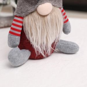 Detailed view of handmade Christmas gnome plush with grey felt hat and white beard
