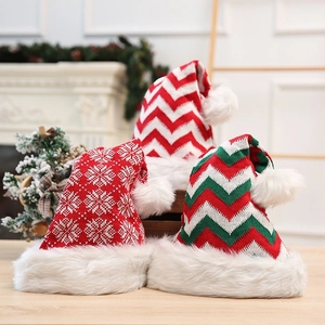Close-up of three knitted Christmas hats with plush pom-poms and thick faux fur lining