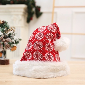 Knitted red Christmas hat with white snowflake patterns and plush faux fur trim