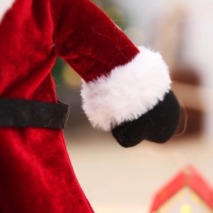 Close-up of velvet Christmas wine bottle dress featuring white faux fur and a black belt