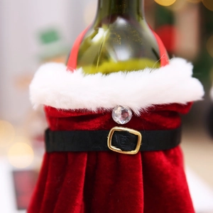 Detailed close-up of Christmas wine bottle cover with red velvet and festive belt decor