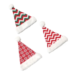 Detail showing three knitted Christmas hats with festive patterns and faux fur trim