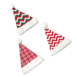 Knitted Christmas hats with red and green patterns and white faux fur pompoms