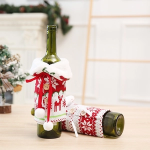 Detail of knitted Christmas wine bottle covers with reindeer and snowflake patterns