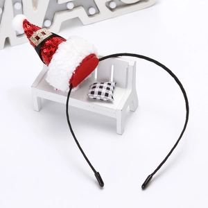 Festive Christmas headband with red sequin mini hat and white fur trim on a black frame