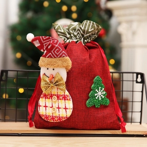 Christmas snowman burlap drawstring gift bag with green glitter tree on wooden stand