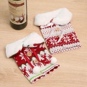 Detail of Christmas knitted wine bottle covers with snowflake patterns and faux fur collars
