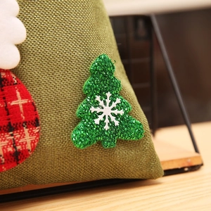 Detailed close-up of burlap Christmas gift bag with a glitter tree and snowflake applique