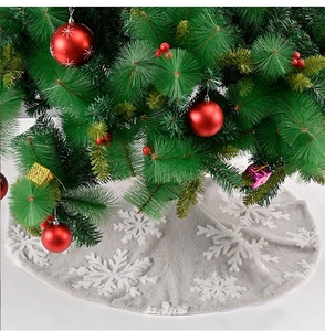 Detail of plush grey Christmas tree skirt with white 3D snowflake patterns and gifts