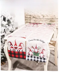 Detail of Christmas table runner featuring Gnomes and plaid patterns on linen fabric