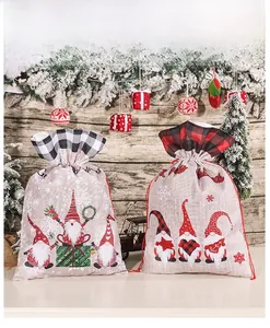 Close-up of gnome pattern Christmas drawstring gift bags with plaid trim and festive decor