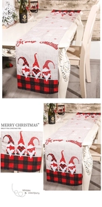 Detail of Christmas table runner with gnomes and red black plaid patterns on a festive table