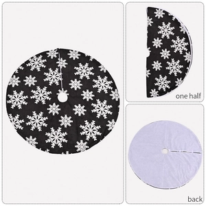 Detail of grey plush Christmas tree skirt featuring white snowflake patterns and soft backing