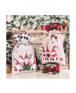 Close-up of linen Christmas drawstring gift bags with gnome prints and plaid patterns