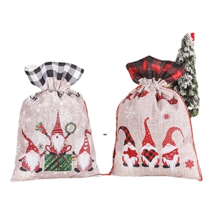 Set of 2 Christmas gnome linen gift bags with festive plaid drawstrings on white background
