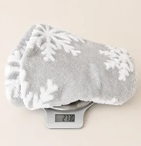 Weight detail of grey Christmas tree skirt with white plush snowflake jacquard fabric
