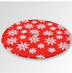 Detail of red plush Christmas tree skirt featuring white snowflake patterns and soft texture