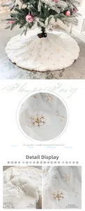 Close-up of white plush Christmas tree skirt with gold and silver sequin snowflake details