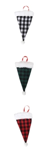 Close-up of three festive plaid Christmas cutlery holders with faux fur trim and tassels