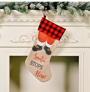 Rustic burlap Christmas stocking with red buffalo plaid trim and Santa Stops Here print
