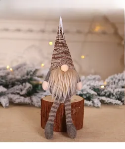 Close-up of Nordic Christmas gnome plush ornament with striped hat and furry beard detail
