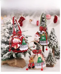 Three Christmas drawstring gift bags featuring snowman, Santa Claus and reindeer characters