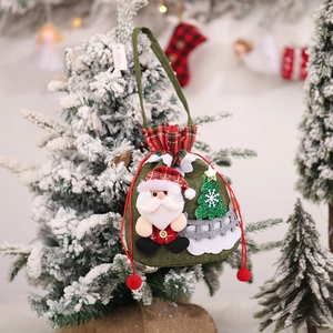 Detail of Christmas Santa burlap gift bag with drawstring on a festive tree