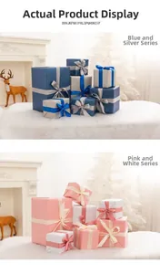 Blue-silver and pink-white holiday gift boxes displayed by a white Christmas tree