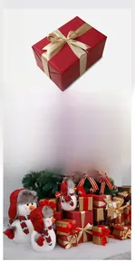 Detail of red and gold Christmas gift box set with festive ribbons and snowman decor