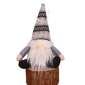 Sitting Nordic Christmas Gnome ornament with knitted hat and long beard on wood base