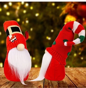 Christmas gnome set with red knitted hats and long white beards on wooden table