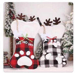 Detail of plaid Christmas stockings with bone shape and deer horns for pet holiday decor
