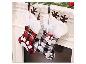 Detail of plaid Christmas pet stockings with white paw prints and bone ornaments