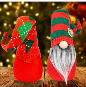 Handmade Christmas gnomes with knitted hats and plush beards on wooden tabletop decor