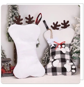 Close-up of bone-shaped plaid Christmas stockings with reindeer antlers and paw prints
