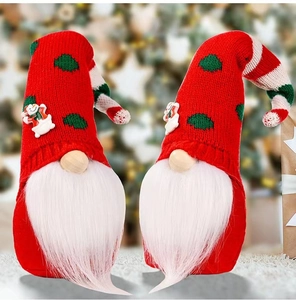 Set of two Christmas gnomes with red knitted hats and white beards on festive background