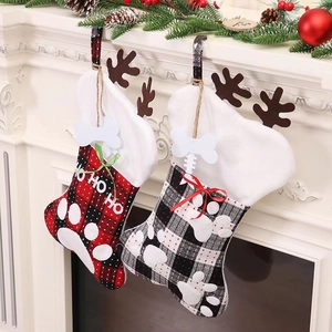 Christmas pet paw stockings in red and black plaid with plush antlers and bone tag