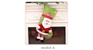 Detail of green 3D Santa Claus Christmas stocking hanging on a white fireplace mantle