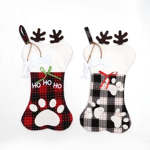 Detail of bone-shaped Christmas stockings with plaid patterns and pet paw print embroidery