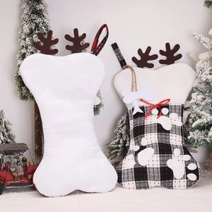 Detail of bone-shaped Christmas stockings with plaid fabric and reindeer antlers