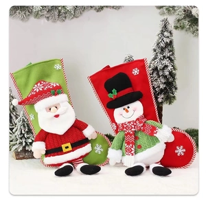 Close-up of 3D Santa and Snowman Christmas stockings with white snowflake embroidery