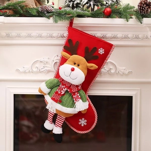 Detail of red Christmas stocking with 3D cartoon reindeer on a white vintage fireplace