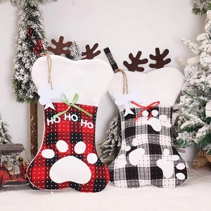 Christmas bone-shaped stockings with plaid patterns, plush reindeer antlers, and paw prints