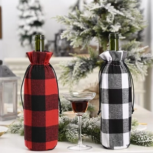 Set of two Christmas plaid wine bottle covers in red, black, and white for holiday decor