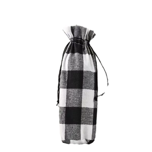 Festive black and white buffalo plaid wine bottle gift bag with a secure drawstring closure