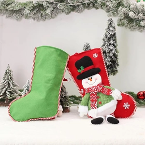 Set of two Christmas stockings with 3D snowman and green design in holiday scene