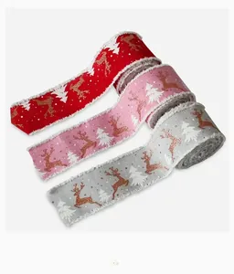 Detail of Christmas ribbons with reindeer and trees prints and white plush edges