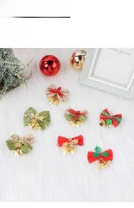 Detail view of 7 assorted Christmas burlap bows with golden bells for holiday tree decoration